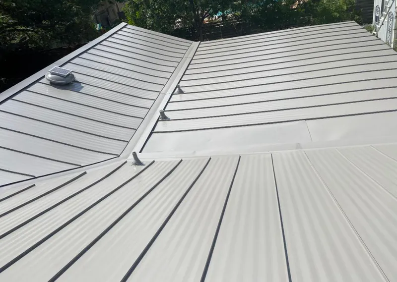Solar attic fan installed on a metal roof for Roof Ventilation in King City